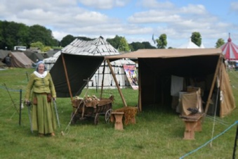 Caroline standing beside our booth, AKA the parent creche, at Chalke Valley History Festival