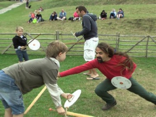 An enthusiastic parent winning at swordplay